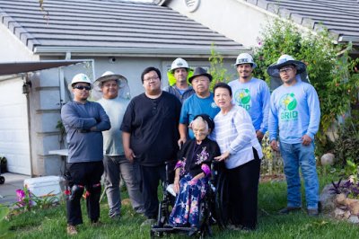 SolarCorps Tong Xiong with a family installing in CV