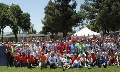 Large group of people gathered outdoors at 2012 Bay Area Solarthon event under white tent