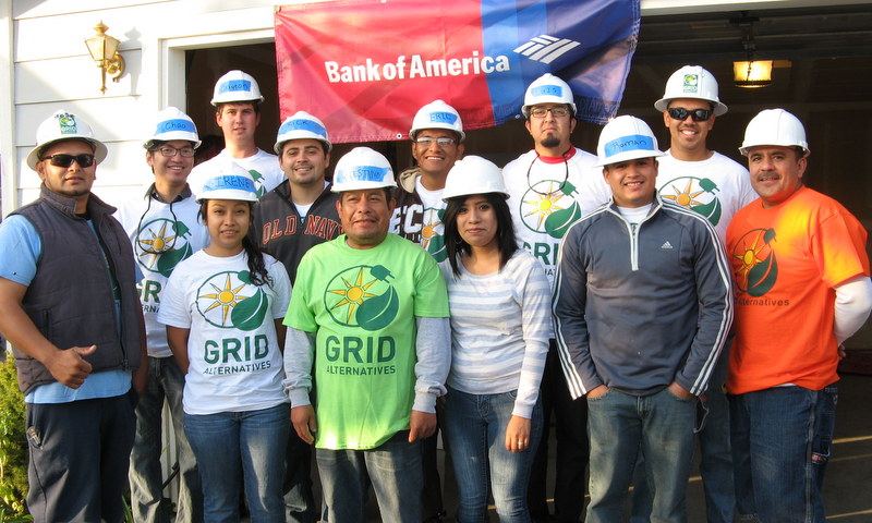 Group of construction workers wearing hard hats and GRID Alternatives shirts at a Bank of America solar project event