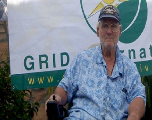 Man in blue patterned shirt and cap at GRID International event