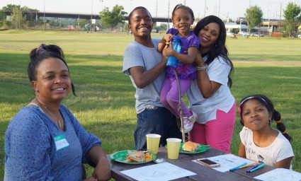 Family enjoying outdoor picnic at a sunny park celebration event