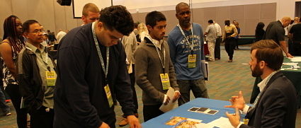 Attendees with lanyards network at a solar job fair event with booths and displays