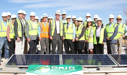 Group of workers in hard hats and safety vests at Colorado Community Solarthon solar panel installation event