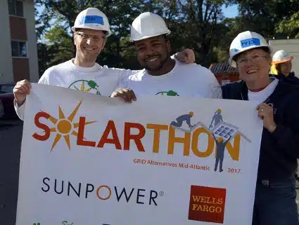 Three Solarthon volunteers take a break from installing solar