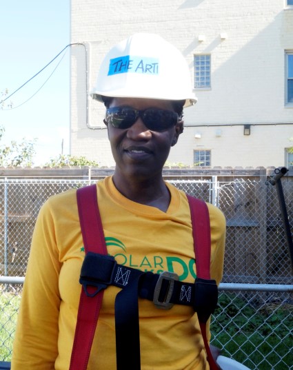 Construction worker in yellow shirt and safety gear wearing ARTI hard hat on job site