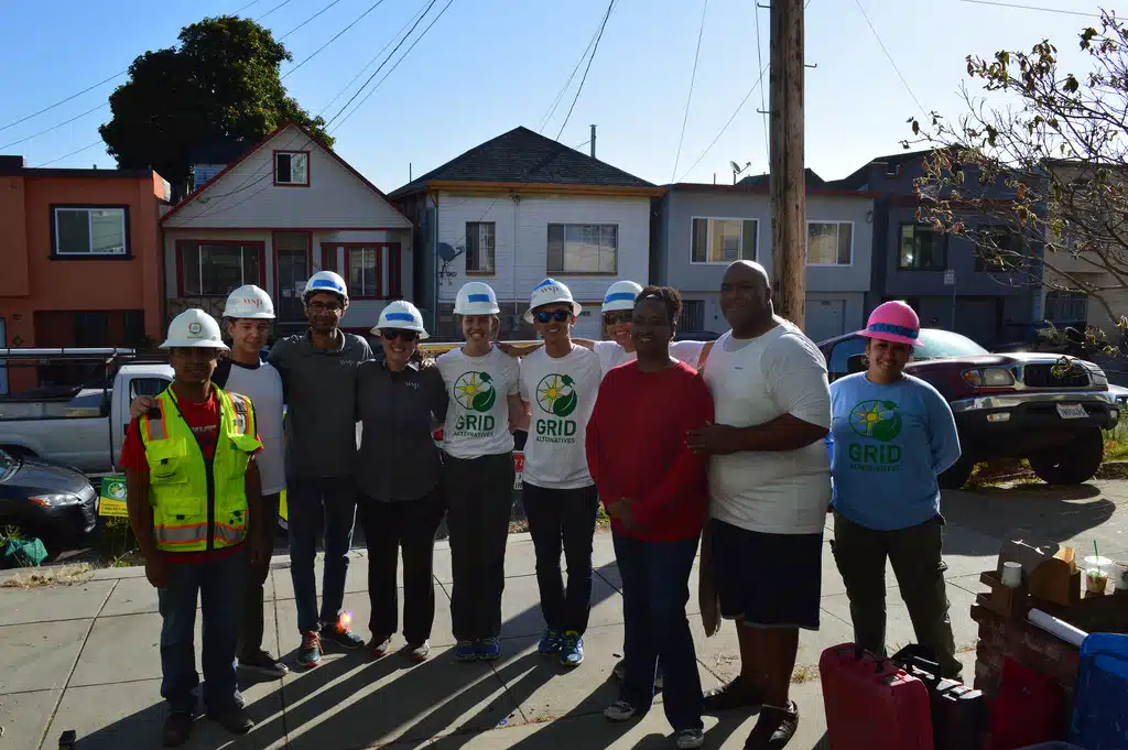 Homeowners Nicole and Mata with their solar installation volunteer team from WSP