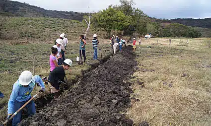 Digging the trenches for the pipes that will distribute the water to the crops.