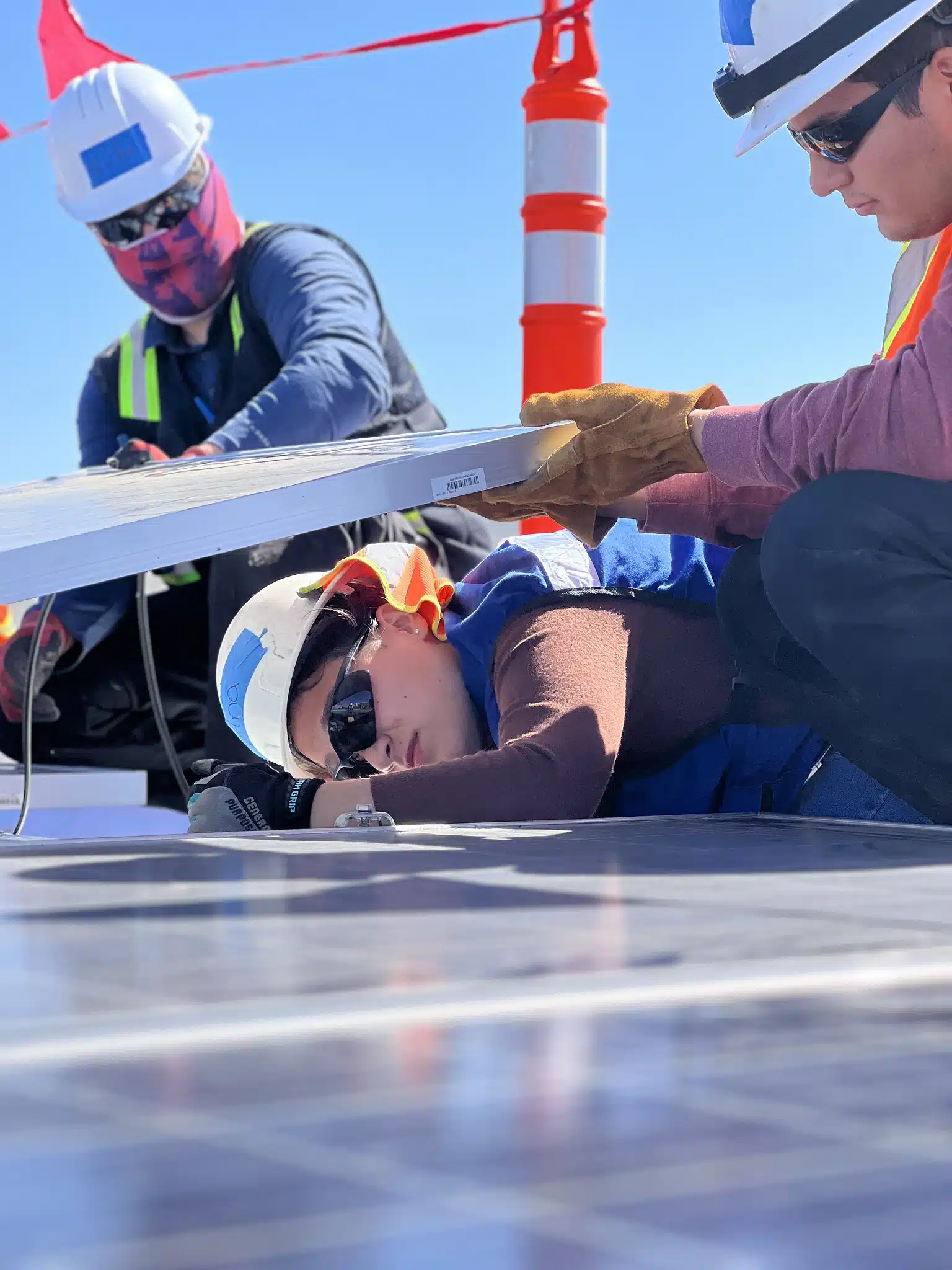Renewable energy students installing solar