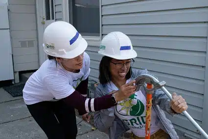 Two Women In Solar participants bending conduit.