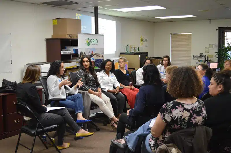 Group of women sitting in circle for discussion at GRID office event