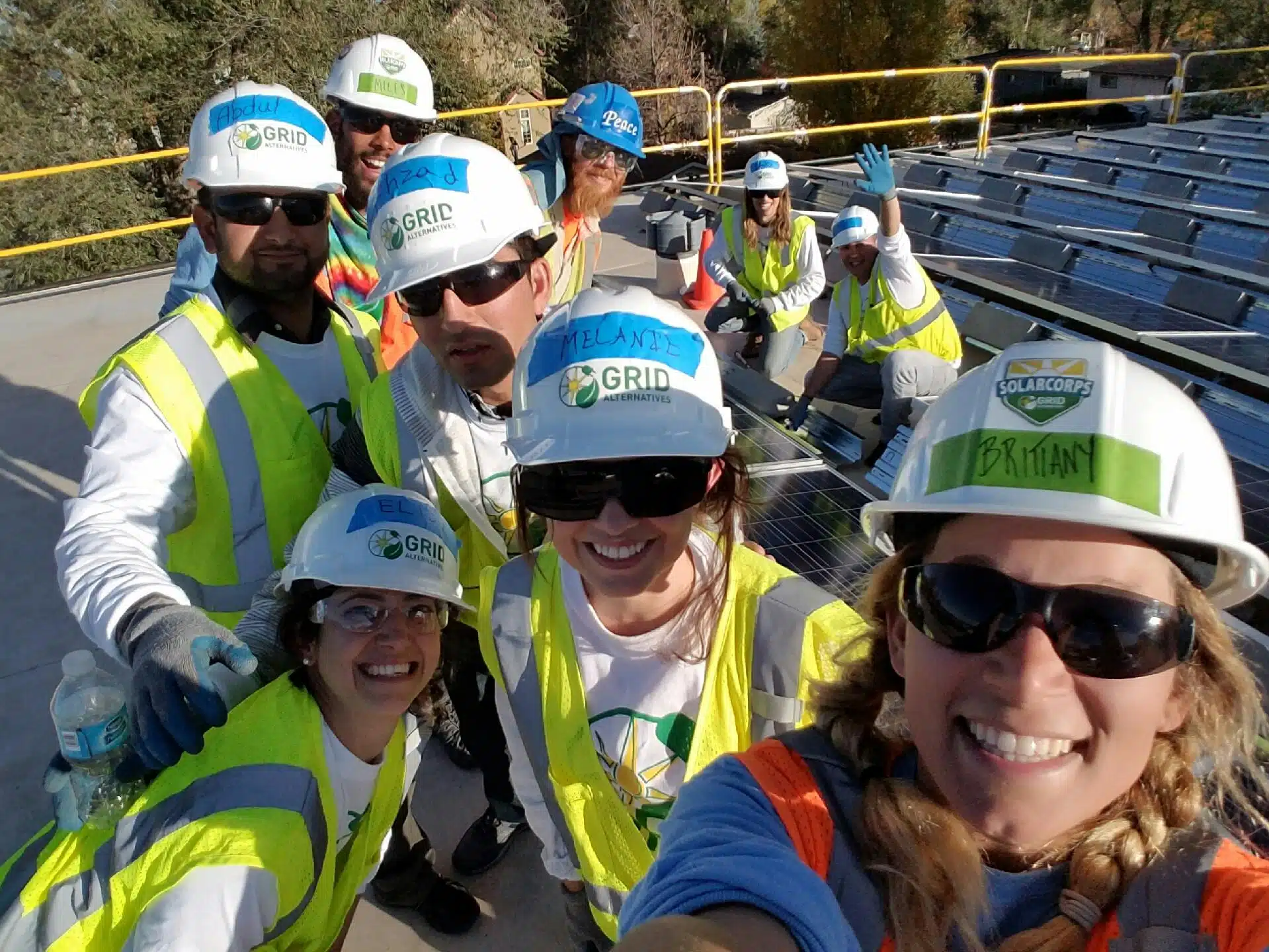 Miles and Brittany take a photo with their volunteers on their first community solar array