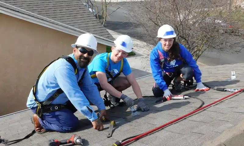 Jenna Poplausky and Samuel Corwin learning on the roof with Adrian Sanchez