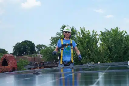 Dave Johnson, SIS at GRID, poses with a completed solar array