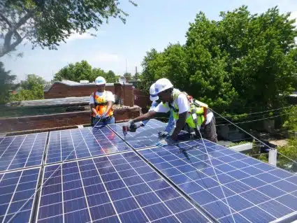 GZEP trainee installing solar panels