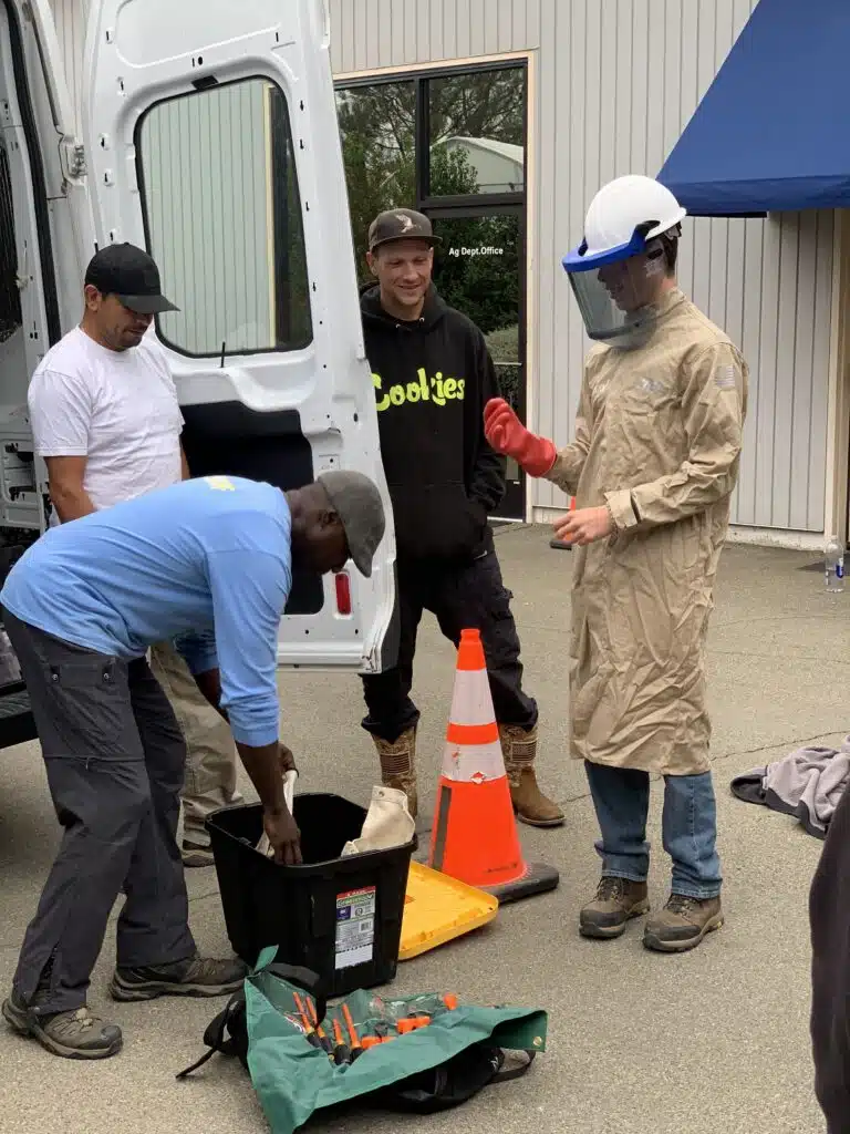 Mendocino College students trying on Personal Protection Equipment at North Coast Bay Area office warehouse
