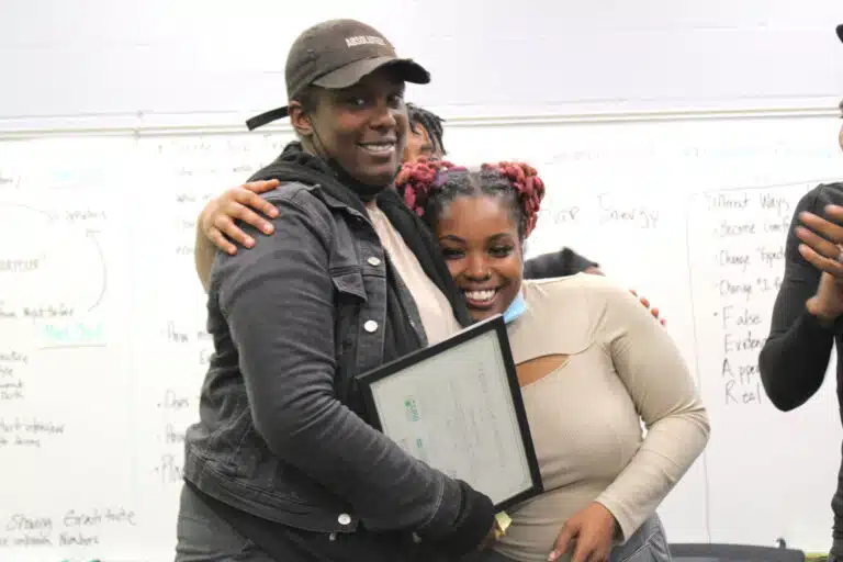 Solar Works DC trainee Shameka (left) celebrates graduating the program with GRID Mid-Atlantic workforce supervisor Dominique.