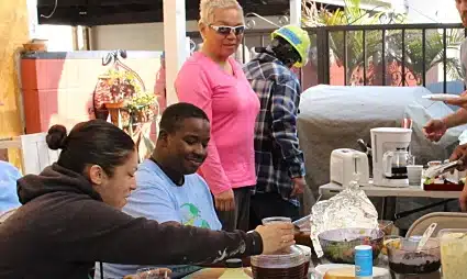 Group of people at outdoor community event preparing food together