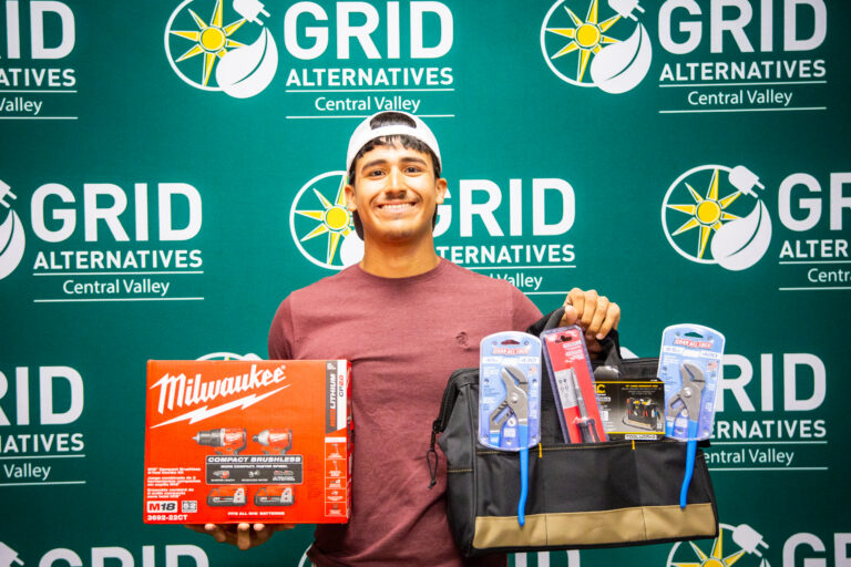 Rudy holding tools for a photo