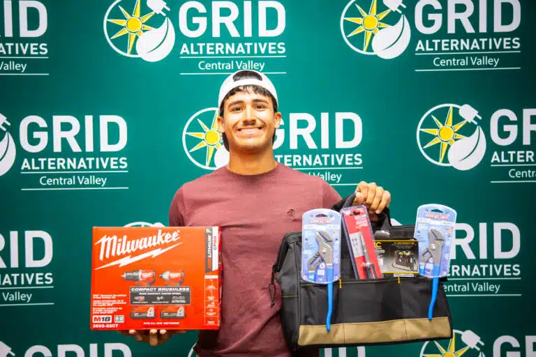 Rudy holding tools for a photo
