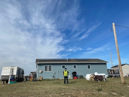 Jaiden stands outside a tribal home in Montana