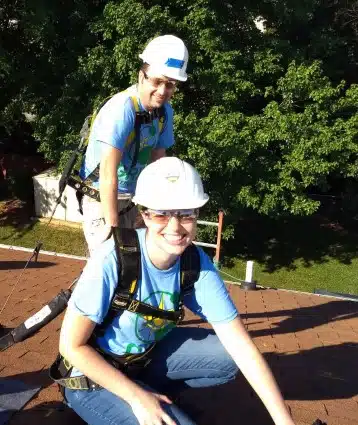 Jeremy and Lacy pose on the roof during a solar installation
