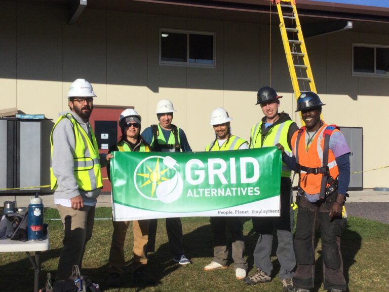 GRID Alternatives Bay Area's North Coast Office Solar Installation Supervisor is posing with Pinoville Pomo Nation Members at an installation of a photovoltaic system in the Nation's community gym