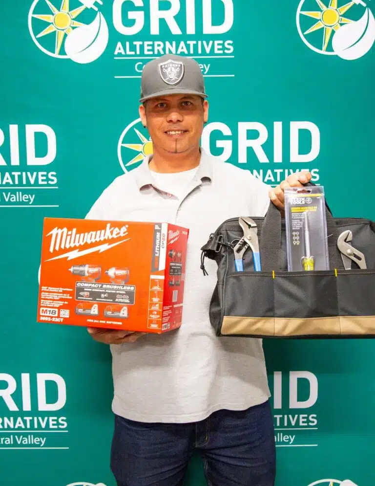 Man holding tool bag for a photo