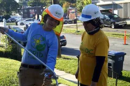 Kaly shows a Solar Works DC trainee how to bend conduit.