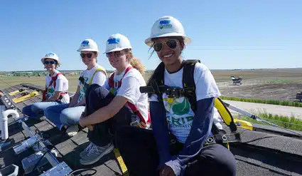 Four GRID volunteers on a roof install