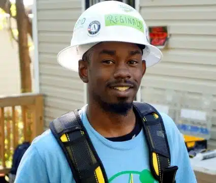 Reggie poses in a GRID staff shirt while on the job site.