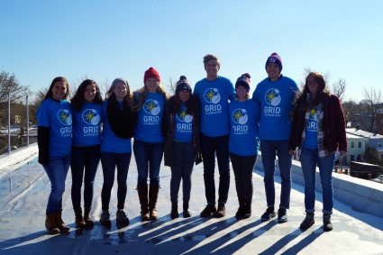 Solar Spring Break students pose in their blue GRID shirts on the roof of the GRID office