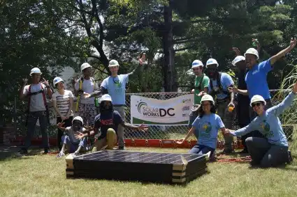 Solar Works DC job trainees pose by a banner