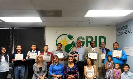 Group of people holding certificates at GRID solar construction cohort graduation ceremony