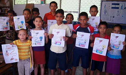 School children at Agua Fria hold up coloring pages showing how solar works.