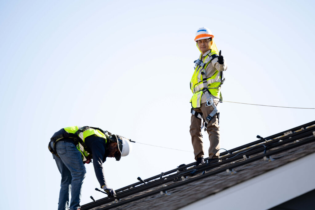 People on roof thumbs up