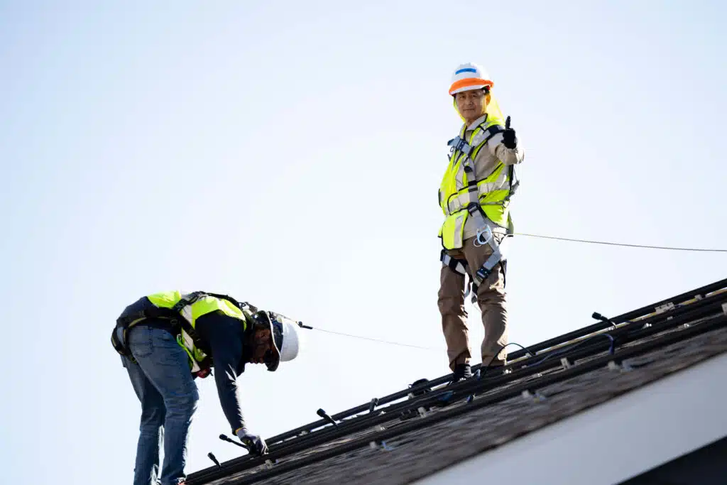 People on roof thumbs up