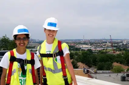 Two SEPA volunteers pose with the DC skyline in the background