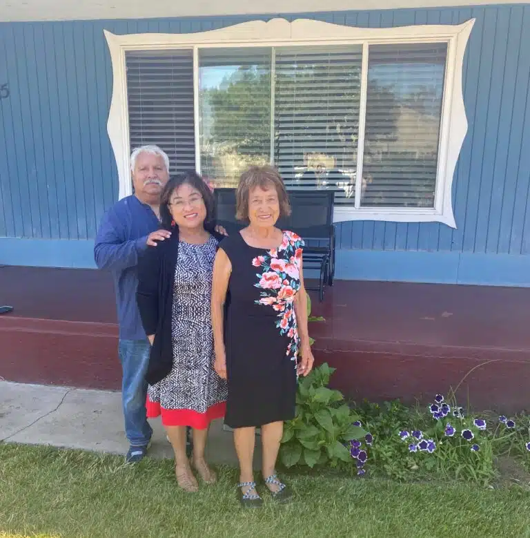 Pauline and her family standing in front of their home.