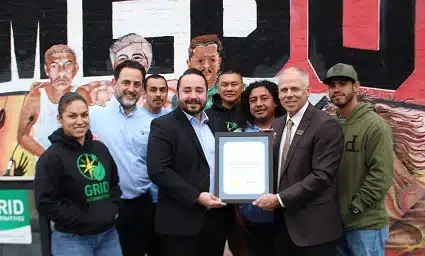 Group of people holding a certificate at a Homeboy event
