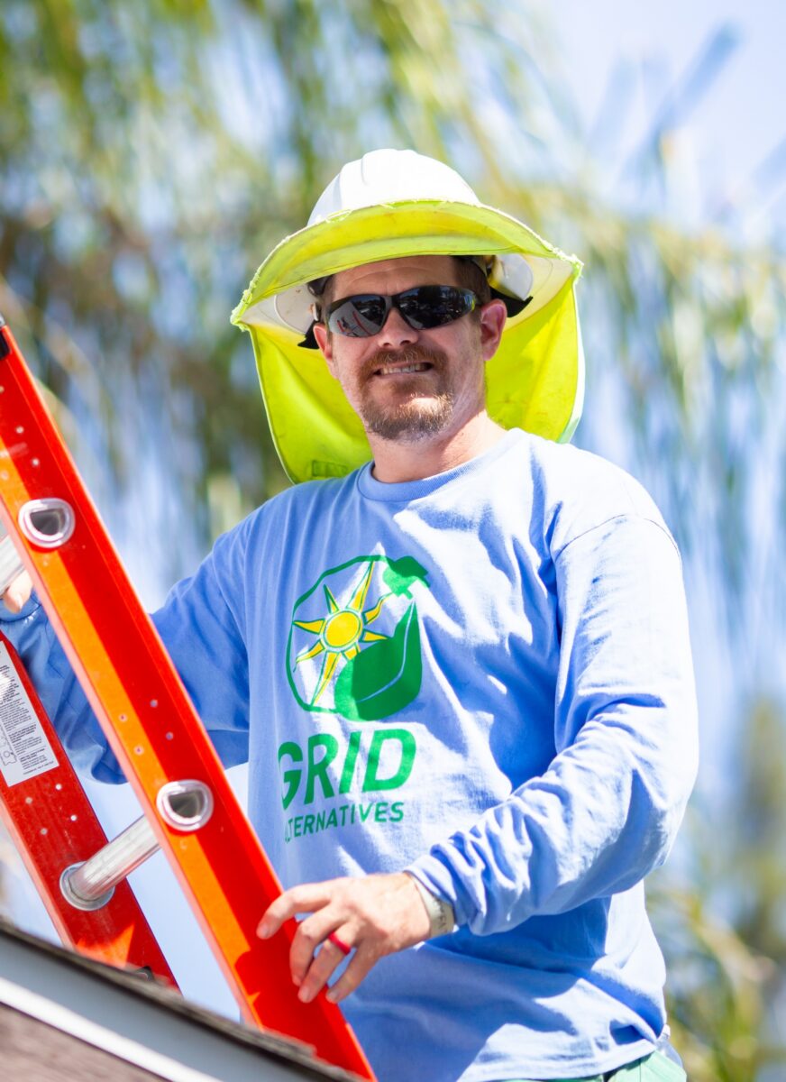 Ken Mull on a ladder in his GRID gear.