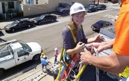 Serena poses on the roof of her very first install in the Central Coast