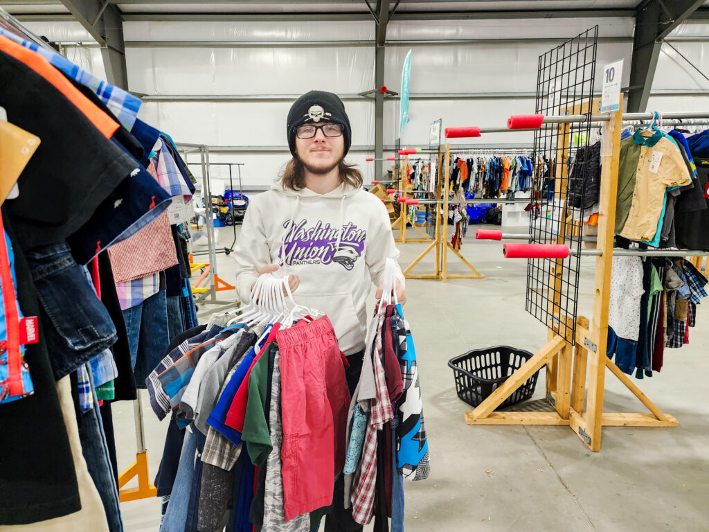 Ayden sorting out clothes and getting ready for consignment