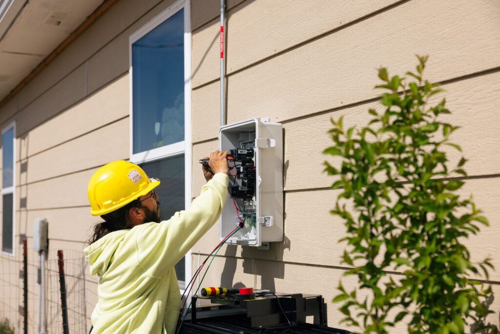 GRID employee checking electrical panel