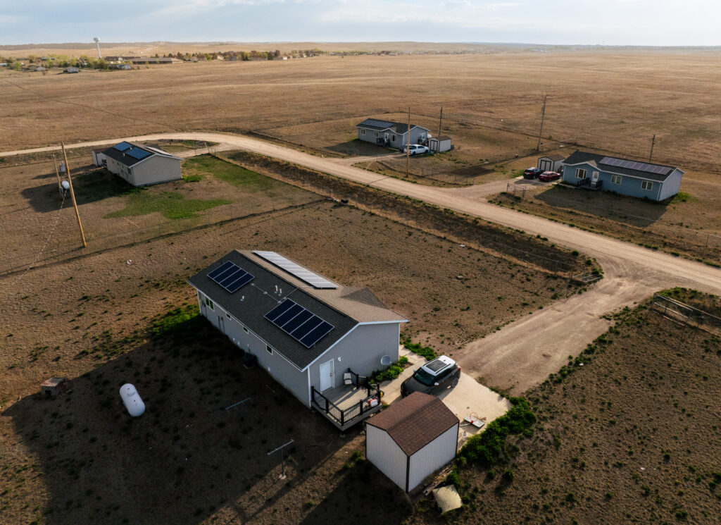 Drone footage of rural homes with rooftop solar, installed by GRID