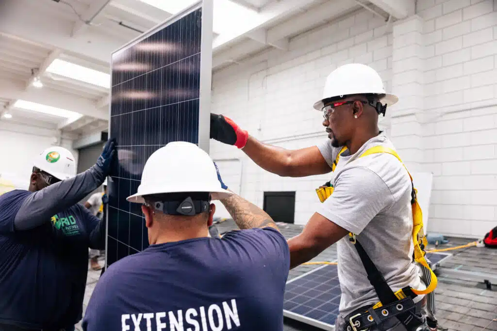 two installers holding solar panel