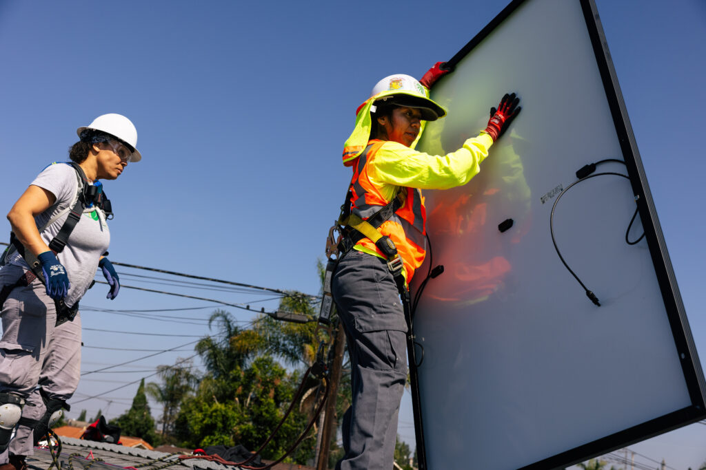 Two installers installing solar on homeowner roof