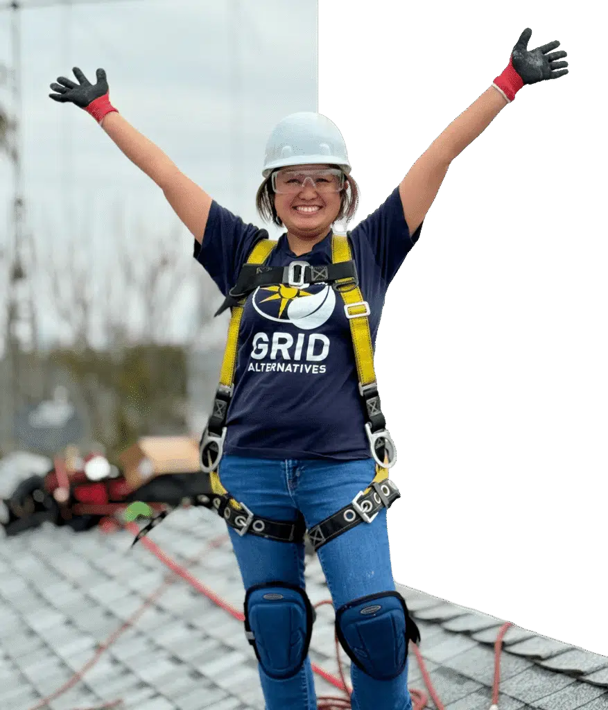 Masked image of person on roof with their arms in the air happy