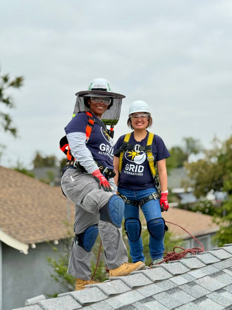 Two people smiling on a roof