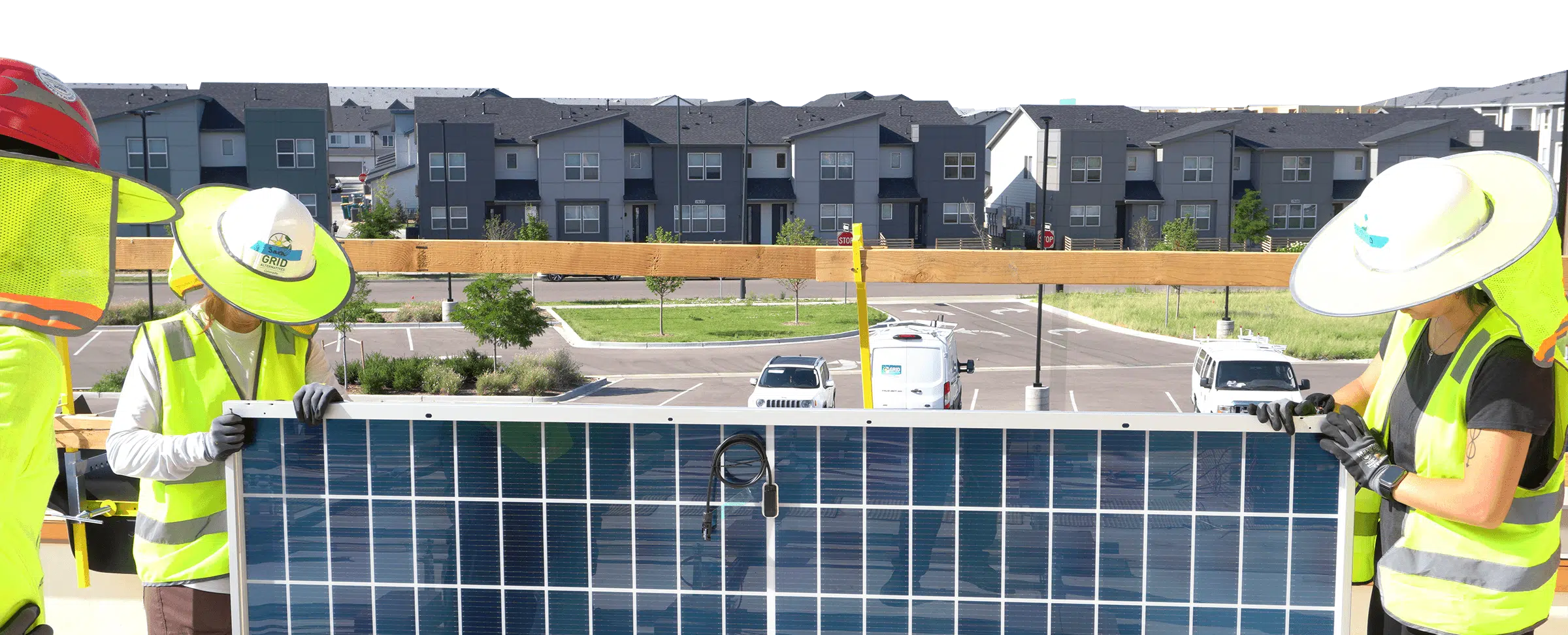 People installing solar panel with houses and condos in the background