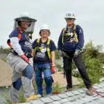 Women SolarCorps fellows on roof with safety equipment